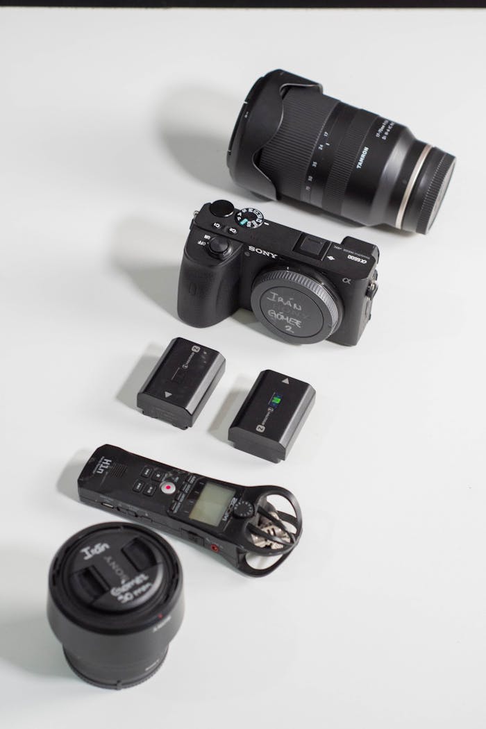 services-06 A flat lay display of photography gear including a camera, lenses, and accessories.