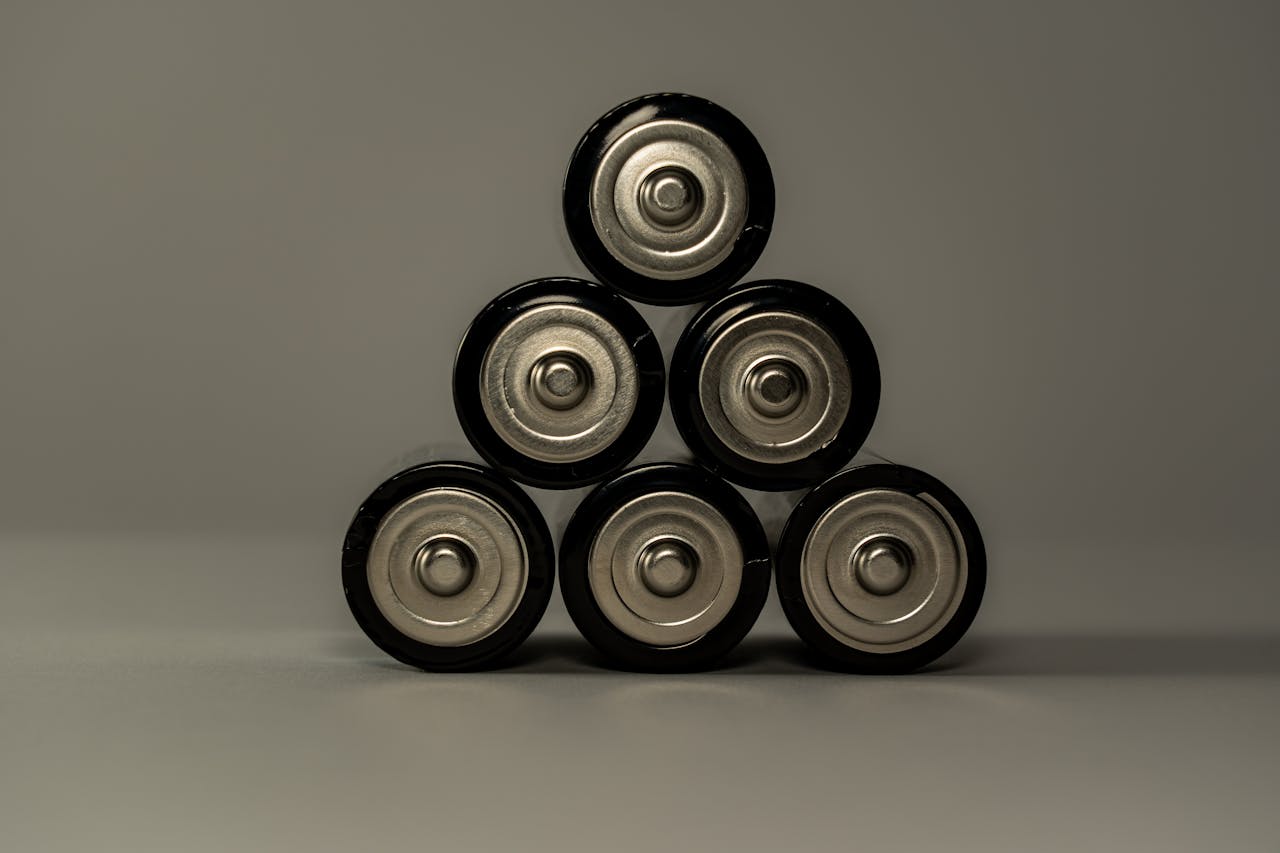 why-choose-us Metallic AA batteries stacked in a pyramid shape, symbolizing power and energy storage.